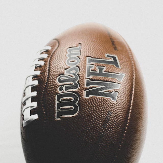 A close-up of a leather Wilson NFL football