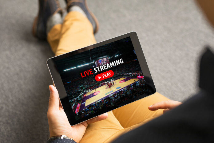 Sports Streaming Man watching sports on live streaming online service