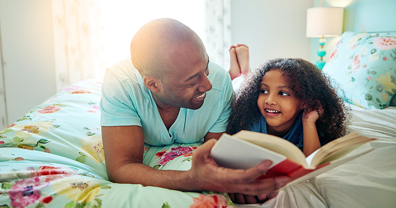 summer_books Dad, girl and smile with storytelling on bed at home for fun, bonding and care with education. Parent, daughter and kid with learning on book reading for knowledge, information and child growth